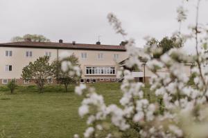 a large building with white flowers in front of it at Vassbo Vandrarhem in Falun