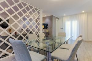 a dining room with a glass table and chairs at MyPlaceLisbon - Lumiar Luxury House in Lisbon