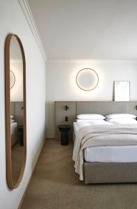 1 Schlafzimmer mit 2 Betten und einem Spiegel in der Unterkunft ADELANTE Boutique Hotel in Berlin