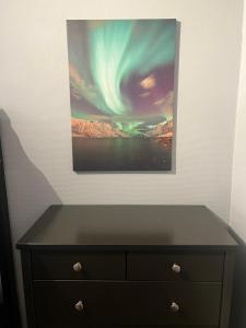 a painting of the sky above a dresser at Comfortable Villa In Lillehammer in Lillehammer