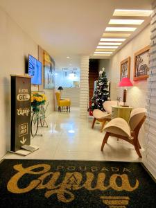 a lobby with a christmas tree in the middle of a room at Pousada Capua Buzios in Búzios