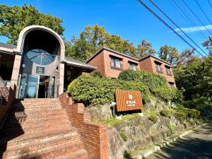 a brick house with a bench in front of it at Izu Kogen Ocean Resort, Ito Villa-TOKI- in Ito