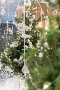 a christmas tree is decorated with ornaments at Hotel & Spa REGENT PETITE FRANCE in Strasbourg