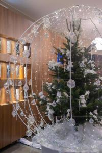 a christmas tree in front of a glass orb at Hotel & Spa REGENT PETITE FRANCE in Strasbourg