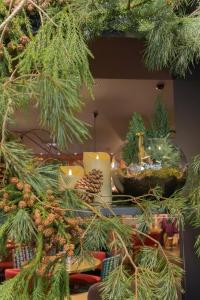 a christmas tree with candles and a bowl of ornaments at BOMA easy living hotel in Strasbourg