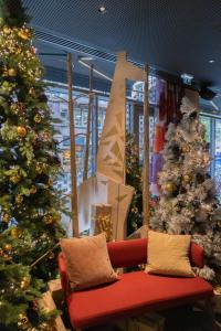 a living room with christmas trees and a red couch at BOMA easy living hotel in Strasbourg