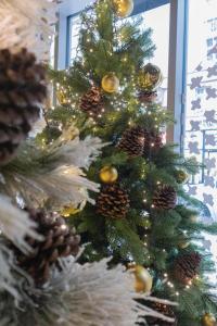 a christmas tree with gold and silver ornaments on it at BOMA easy living hotel in Strasbourg