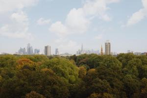 a view of the city from above the trees at Royal Garden Hotel in London