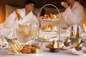 a table topped with plates of food and drinks at Royal Garden Hotel in London