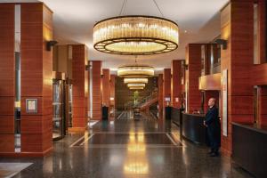 a man standing in the lobby of a hotel at Royal Garden Hotel in London