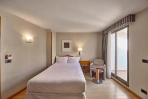 a hotel room with a bed and a window at Civis Jaime I in Castellón de la Plana