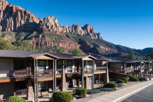 a hotel with a mountain in the background at The Red Cliffs Lodge Zion, a Tribute Portfolio Hotel in Springdale