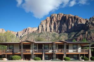 a hotel with a mountain in the background at The Red Cliffs Lodge Zion, a Tribute Portfolio Hotel in Springdale