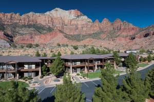 a view of a hotel with a mountain in the background at The Red Cliffs Lodge Zion, a Tribute Portfolio Hotel in Springdale