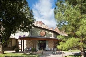 a building with a mountain in the background at The Red Cliffs Lodge Zion, a Tribute Portfolio Hotel in Springdale