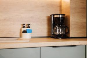 a coffeemaker sitting on top of a kitchen counter at Apartment Oasis in Osijek