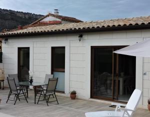 une terrasse avec une table, des chaises et un parasol dans l'établissement La Costana De Barbadillo, à Barbadillo del Mercado