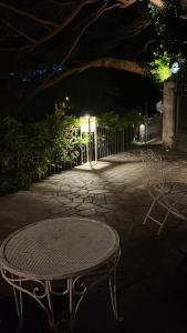 a table and chairs on a patio at night at Villa Varenna in Varenna