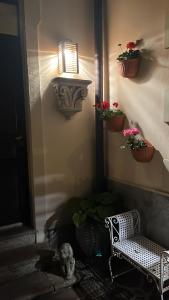 a room with a chair and potted plants and a light at Villa Varenna in Varenna