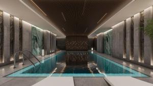 a swimming pool in the lobby of a hotel at voco Jeddah Gate, an IHG Hotel in Jeddah