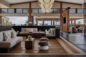 a living room with a couch and a table at AC Hotel by Marriott Maui Wailea in Wailea