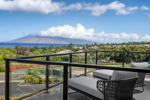 a balcony with chairs and a view of the ocean at AC Hotel by Marriott Maui Wailea in Wailea