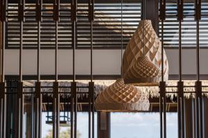 a light fixture hanging from a wall in a building at AC Hotel by Marriott Maui Wailea in Wailea