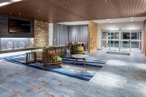 a lobby with couches and a table and chairs at Fairfield by Marriott Port Clinton Waterfront in Port Clinton