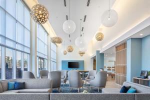 a lobby with couches and tables and windows at Element Knoxville West in Knoxville