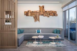 a living room with a couch and a chandelier at Element Knoxville West in Knoxville