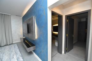 a bathroom with a blue wall with a sink at Palazzo hotel in Kuwait