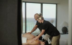 a man and a woman standing next to a large dummy at Lotus Honolulu at Diamond Head in Honolulu