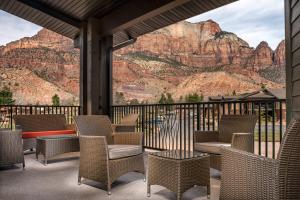 a patio with chairs and a view of a mountain at SpringHill Suites by Marriott Springdale Zion National Park in Springdale