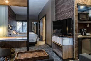 a hotel room with a bed and a tv at SpringHill Suites by Marriott Springdale Zion National Park in Springdale