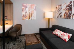 sala de estar con sofá y silla en SpringHill Suites by Marriott Kansas City Northeast, en Kansas City