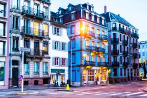 a group of tall buildings on a city street at Hotel Roses in Strasbourg