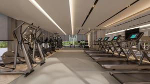 a gym with a row of tread machines at voco Jeddah Gate, an IHG Hotel in Jeddah