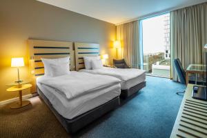 Giường trong phòng chung tại Clarion Hotel Copenhagen Airport