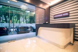 a store front with a car parked in a parking lot at 33 Boutique Hotel Bandar Sunway in Petaling Jaya