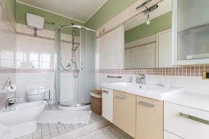 a bathroom with a shower and a sink and a toilet at B&B Mareya in Cagliari