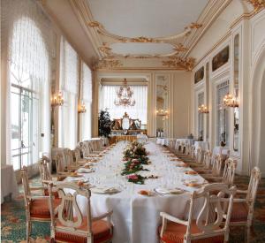 a long dining room with a long table and chairs at Grand Hotel des Iles Borromées & SPA in Stresa