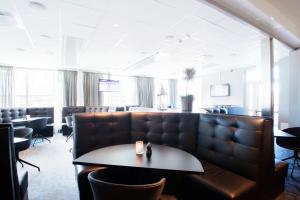 a waiting room with a couch and a table at RC Hotel Sport's & Business in Jönköping