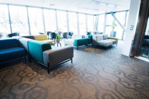 a waiting room with couches and chairs in a building at RC Hotel Sport's & Business in Jönköping