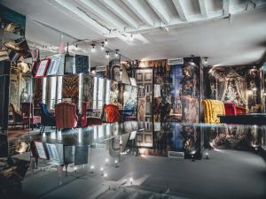 a room with a glass table and posters on the wall at Hotel Le Notre Dame Saint Michel in Paris