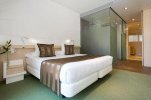 A bed or beds in a room at Ako Suites Hotel