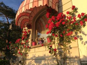 a window with red flowers on the side of a building at Villa Varenna in Varenna