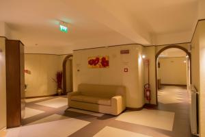 a waiting room with a couch in a building at Albergo della Posta in Taverna