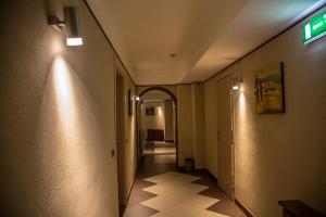 a hallway with an exit sign on the wall at Albergo della Posta in Taverna