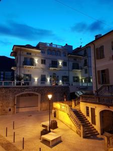 a building with a staircase and a building with a street light at Hotel Al Campanile - Luxury Suites & Apartments in Baveno