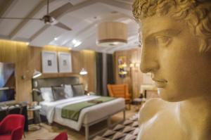 a statue of a woman in a room with a bed at Browns Central Hotel in Lisbon